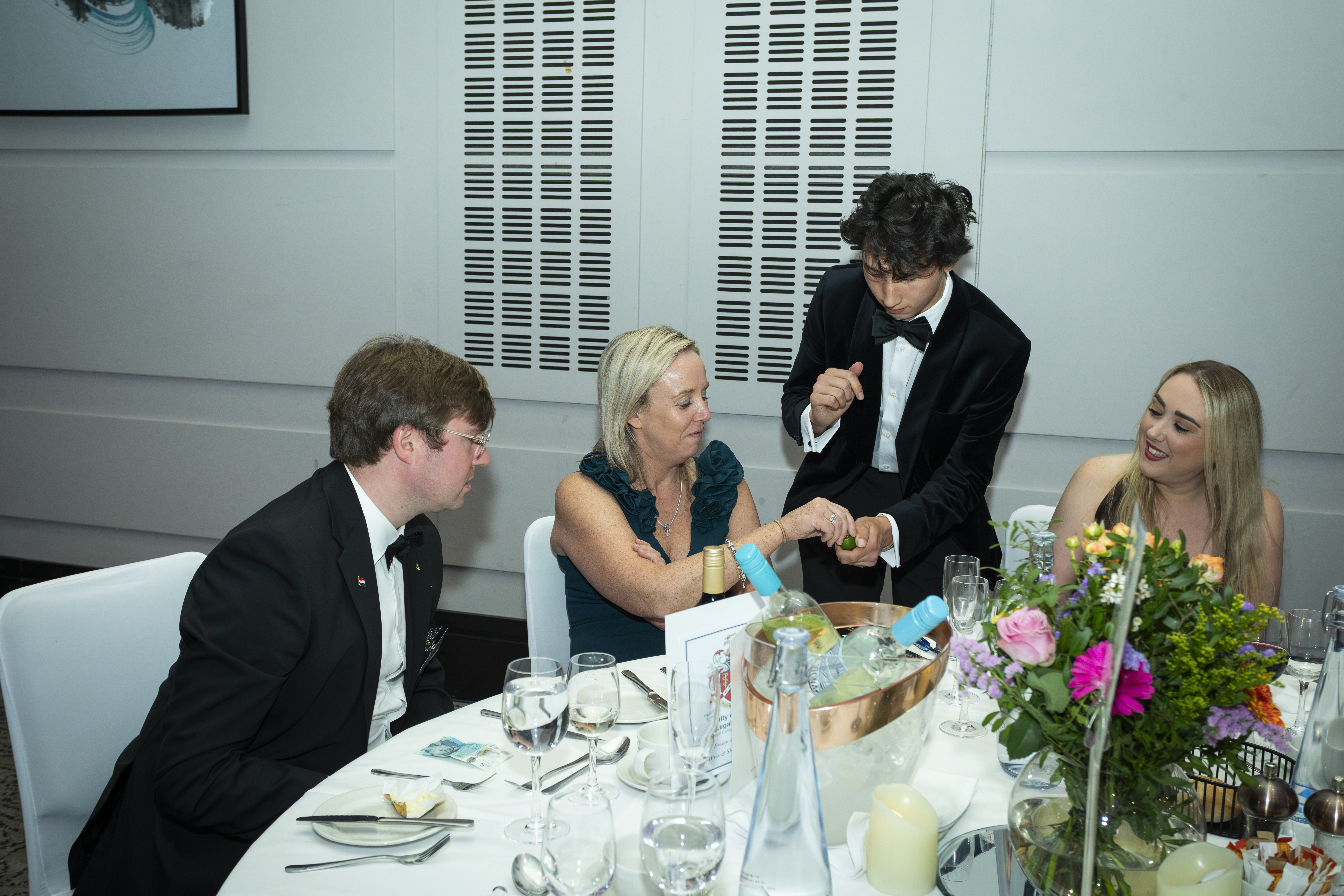 A close-up magic performance at a formal event